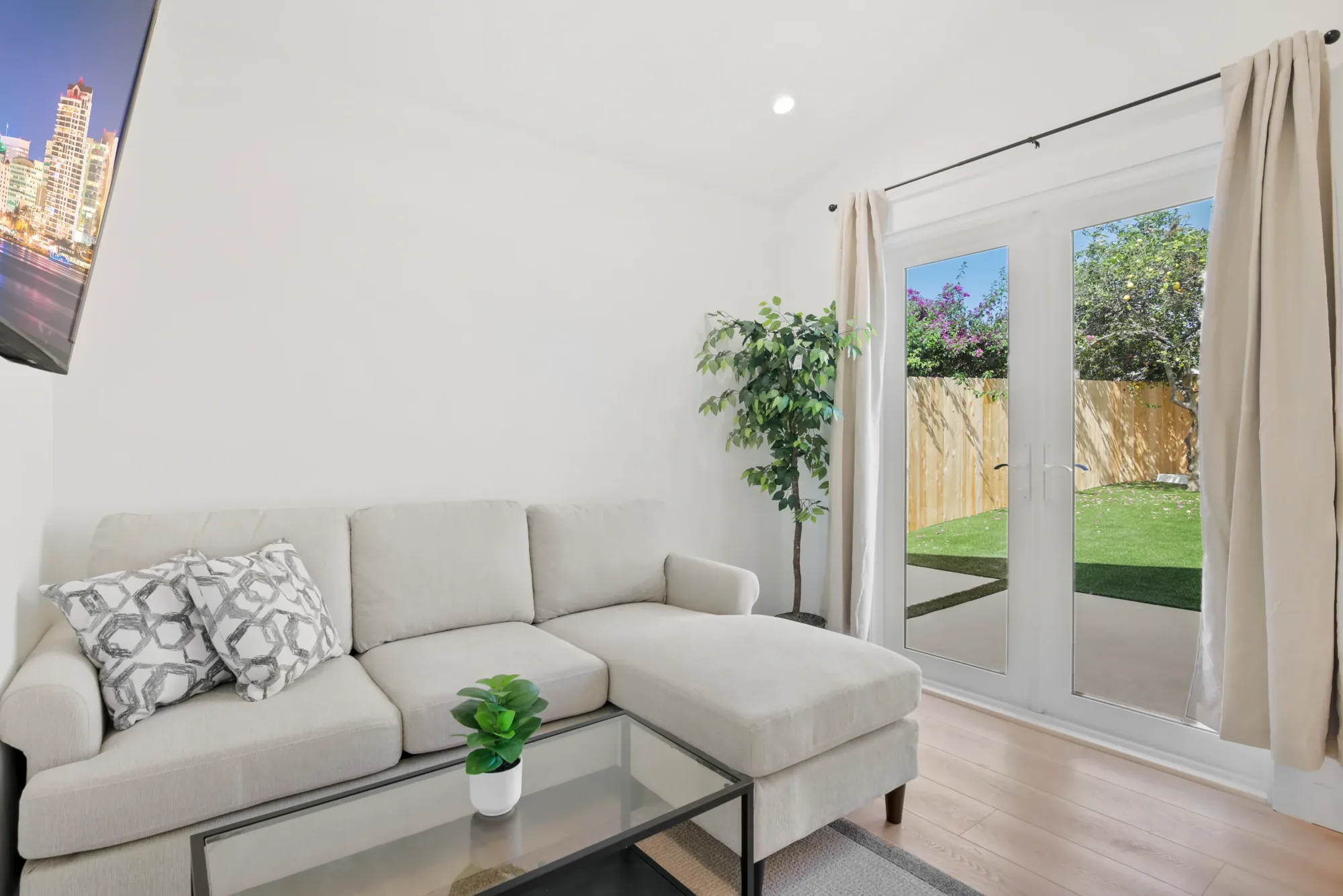ADU living space with sofa and doors to the yard