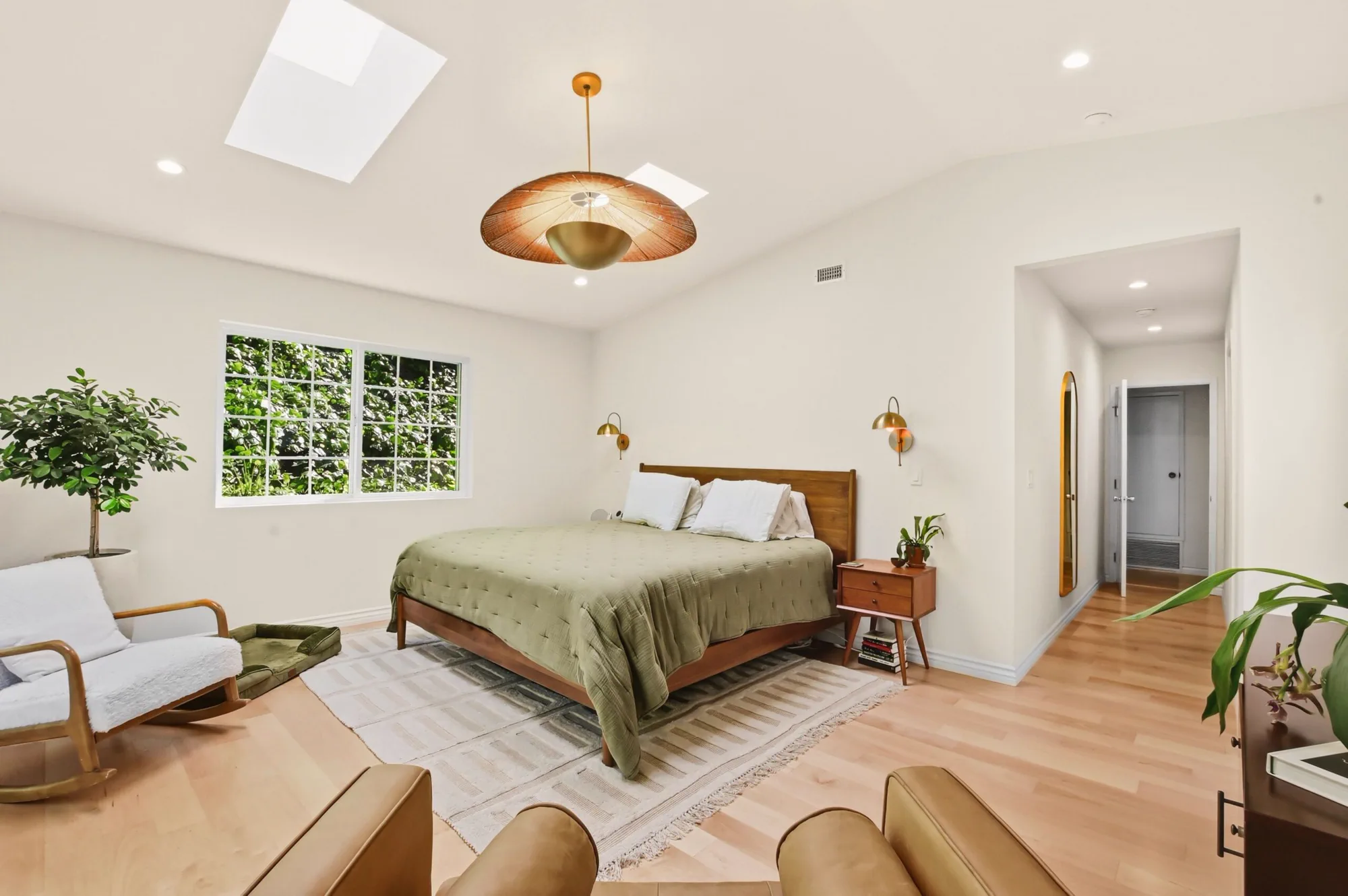 Remodeled primary bedroom with vaulted ceiling