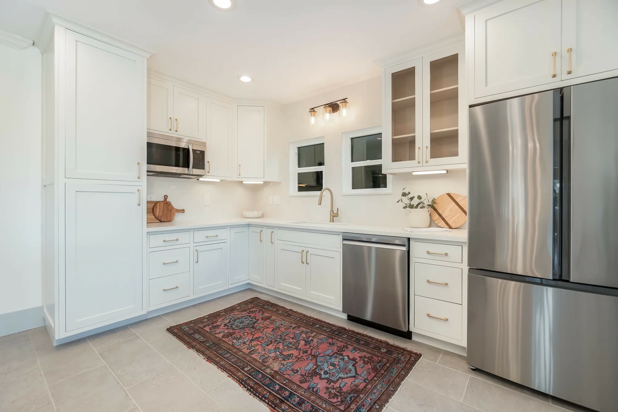 Remodeled white kitchen with brass hardware
