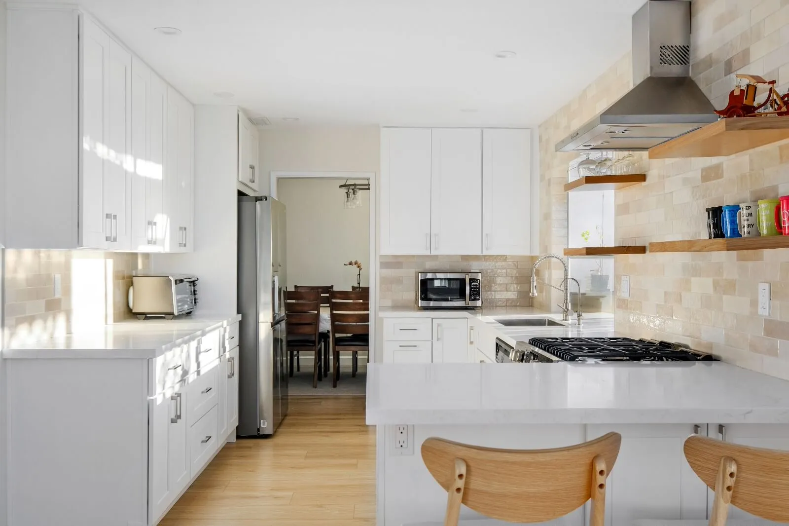 Open kitchen remodel with island and bar seating in Linda Vista San Diego by Elements Design & Build