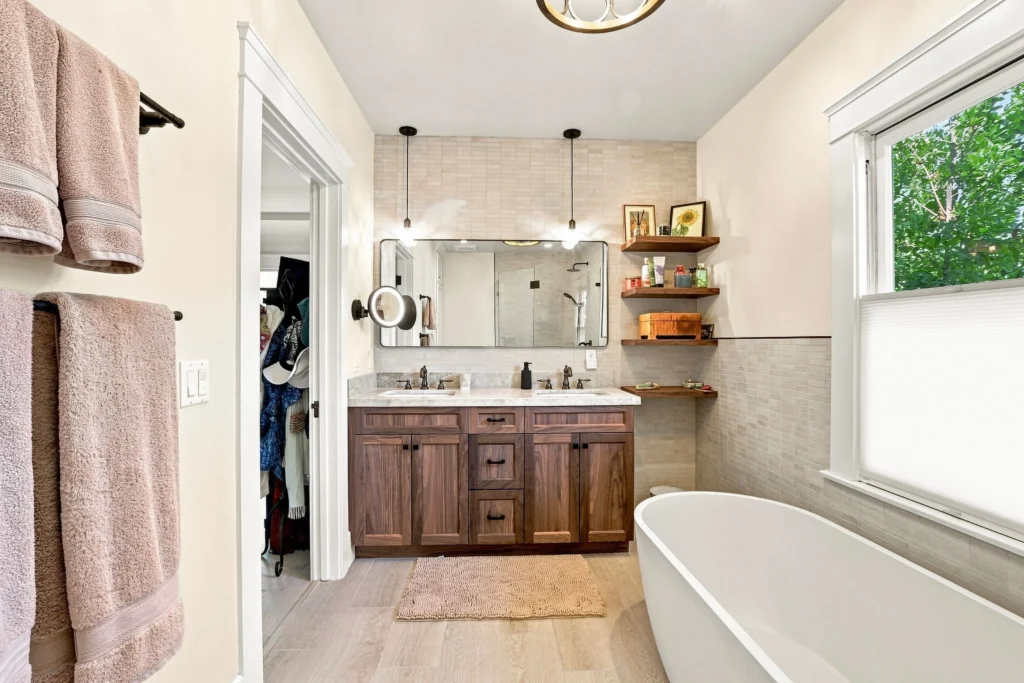 Primary bathroom with floating vanity, wood shelves and walk-in shower